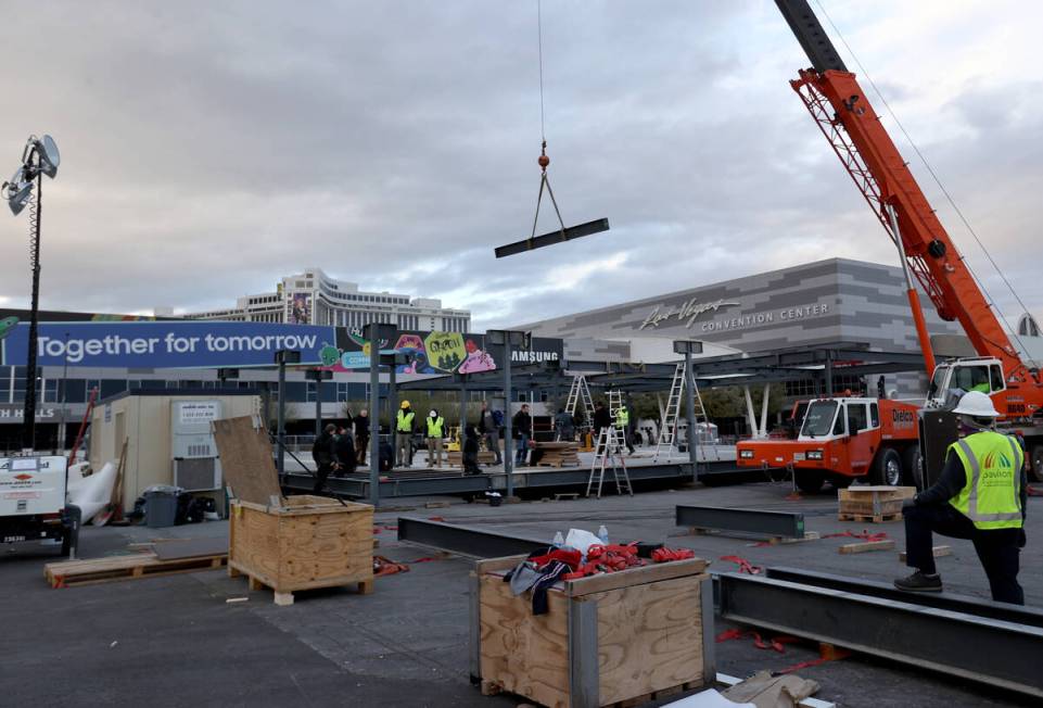 Workers prepare for CES at the Las Vegas Convention Center Thursday, Dec. 30, 2021. The trade s ...