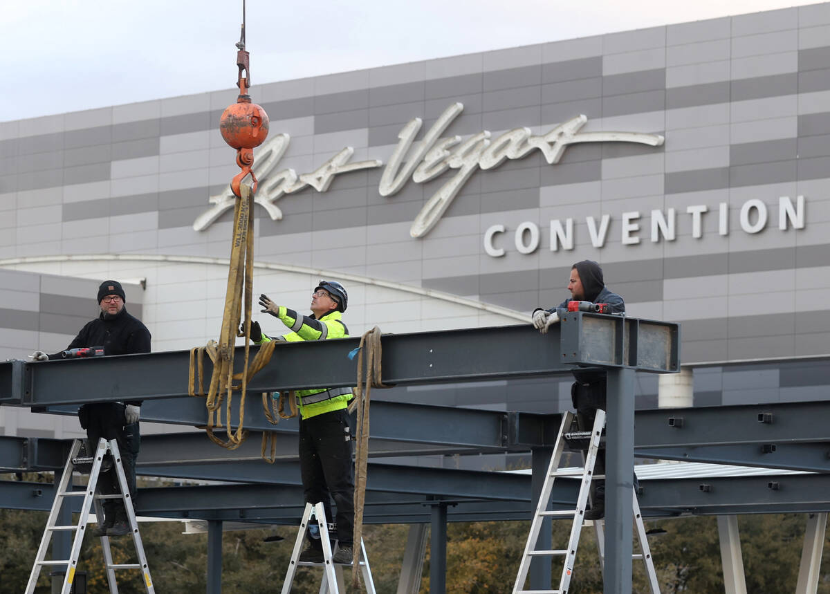 Workers prepare for CES at the Las Vegas Convention Center Thursday, Dec. 30, 2021. The trade s ...