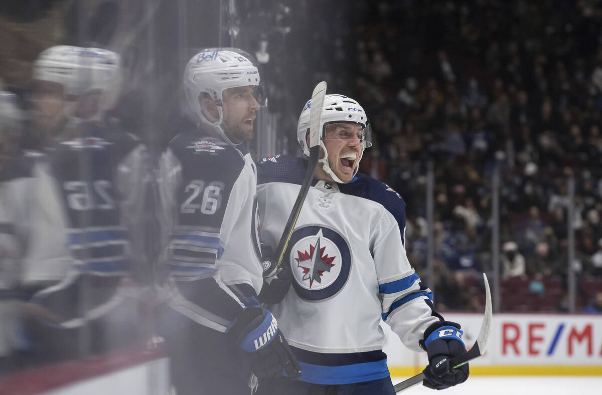 Winnipeg Jets' Blake Wheeler, left, and Nate Schmidt celebrate Wheeler's goal against the Vanco ...