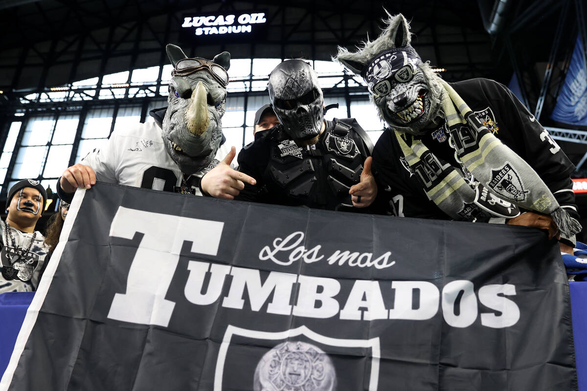 Fans poses for a photo before the start of an NFL football game between the Raiders and the Ind ...