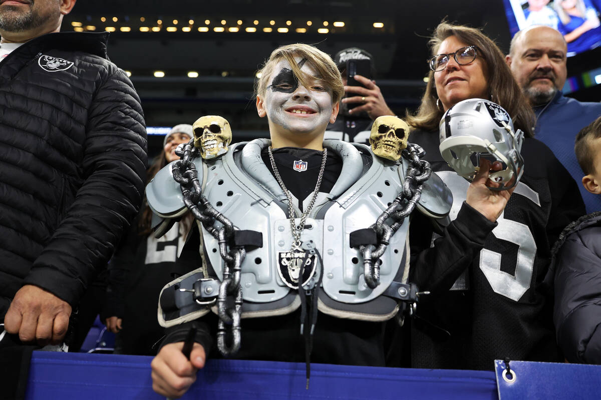 Quincyʋoch, 10, of Illinois, attends an NFL football game between the Raiders and the Ind ...