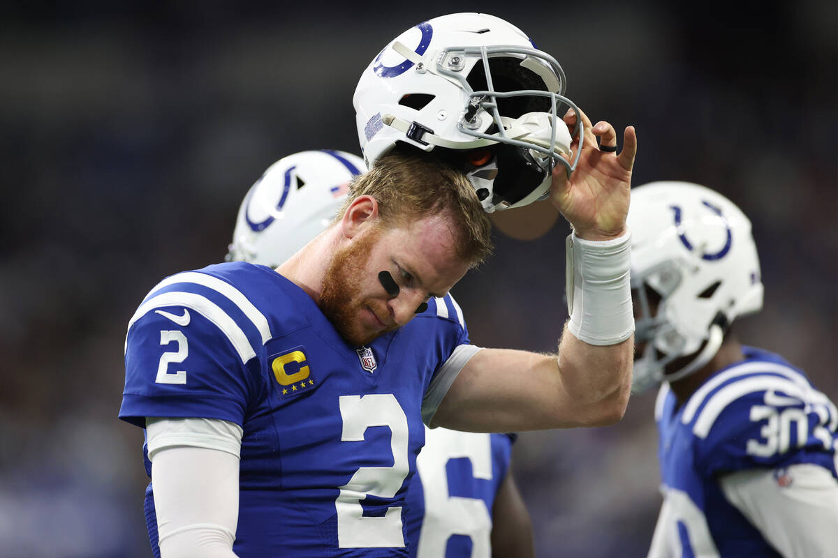 Indianapolis Colts quarterback Carson Wentz (2) walks off the field after an incomplete pass du ...