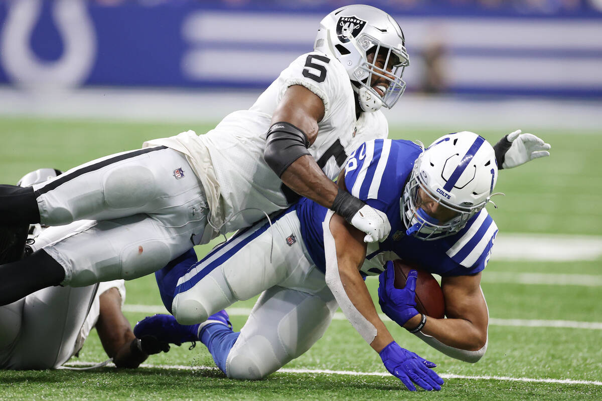 Raiders linebacker Divine Deablo (5) tackles Indianapolis Colts running back Jonathan Taylor (2 ...
