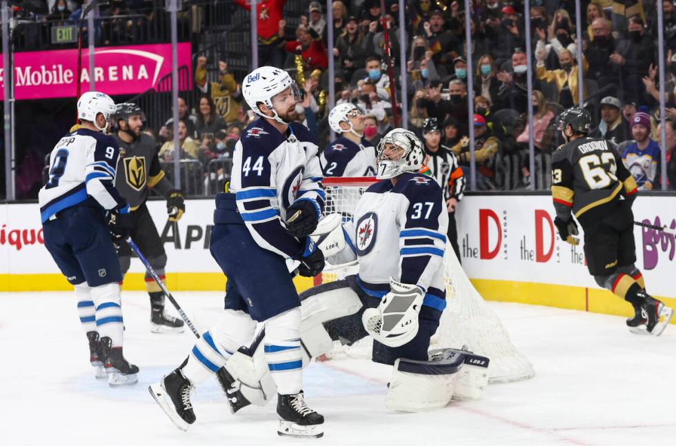 Winnipeg Jets goaltender Connor Hellebuyck (37) gives up a goal to Golden Knights right wing Ev ...