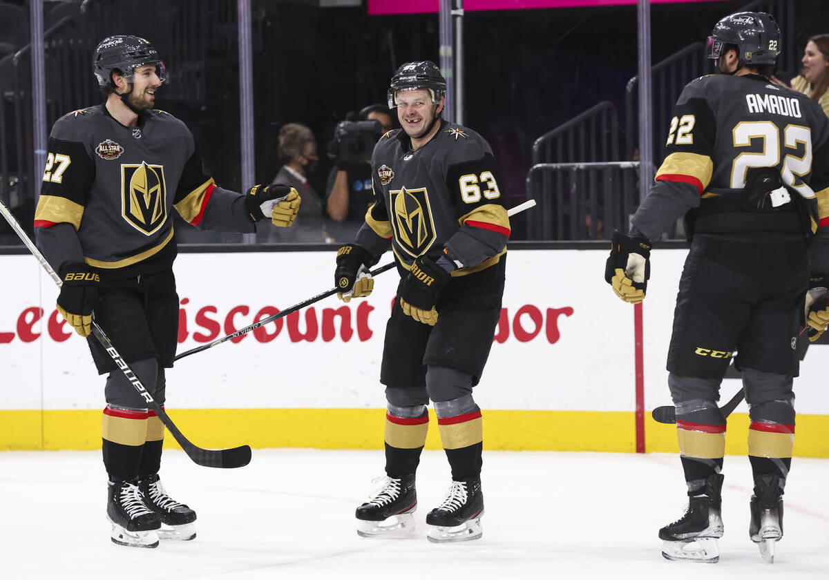 Golden Knights right wing Evgenii Dadonov (63) celebrates his goal with defenseman Shea Theodor ...