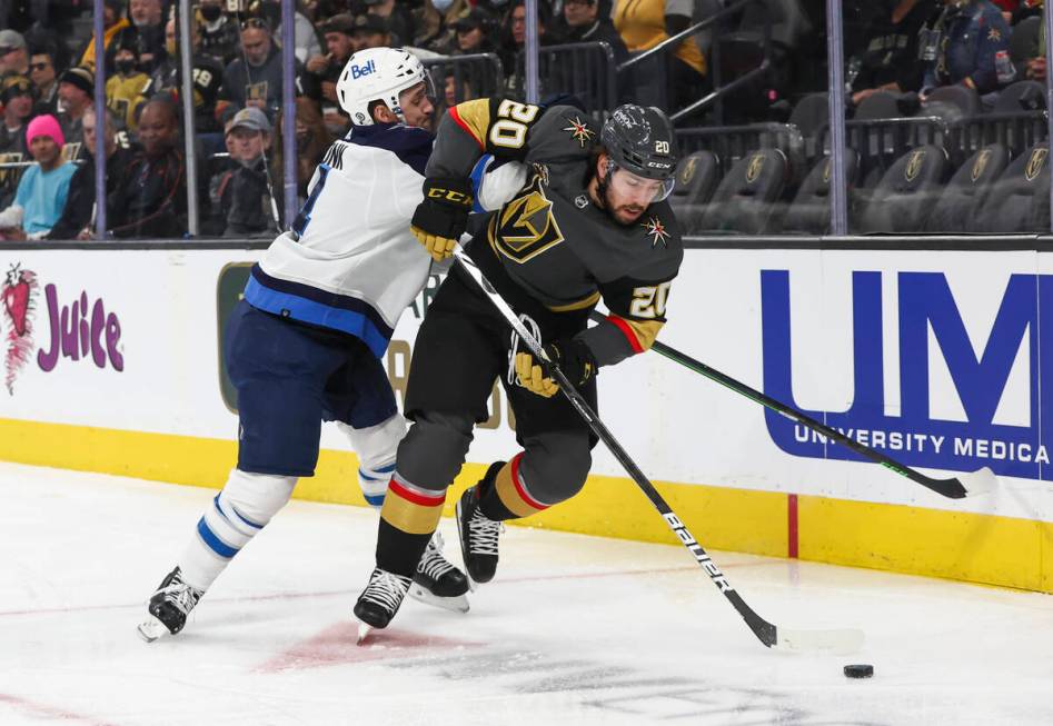 Golden Knights center Chandler Stephenson (20) skates with the puck past Winnipeg Jets defensem ...