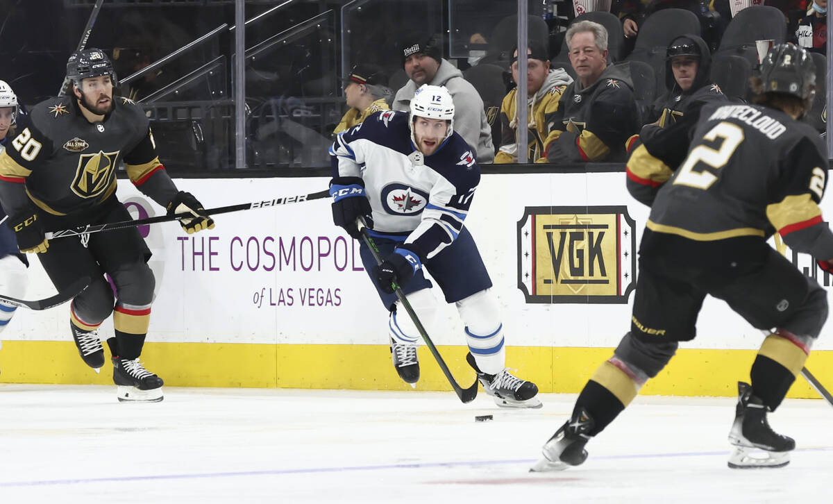 Winnipeg Jets center Jansen Harkins (12) skates with the puck against the Golden Knights during ...