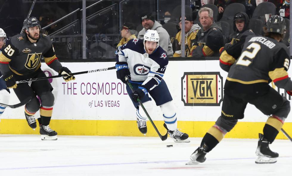 Winnipeg Jets center Jansen Harkins (12) skates with the puck against the Golden Knights during ...