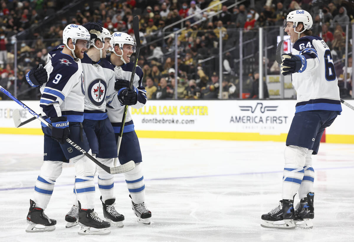 The Winnipeg Jets celebrate after scoring against the Golden Knights during the second period o ...