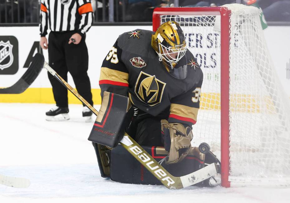 Golden Knights goaltender Laurent Brossoit (39) blocks the puck in front of Winnipeg Jets left ...