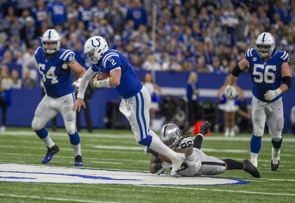 Raiders defensive tackle Darius Philon (96) brings down Indianapolis Colts quarterback Carson W ...