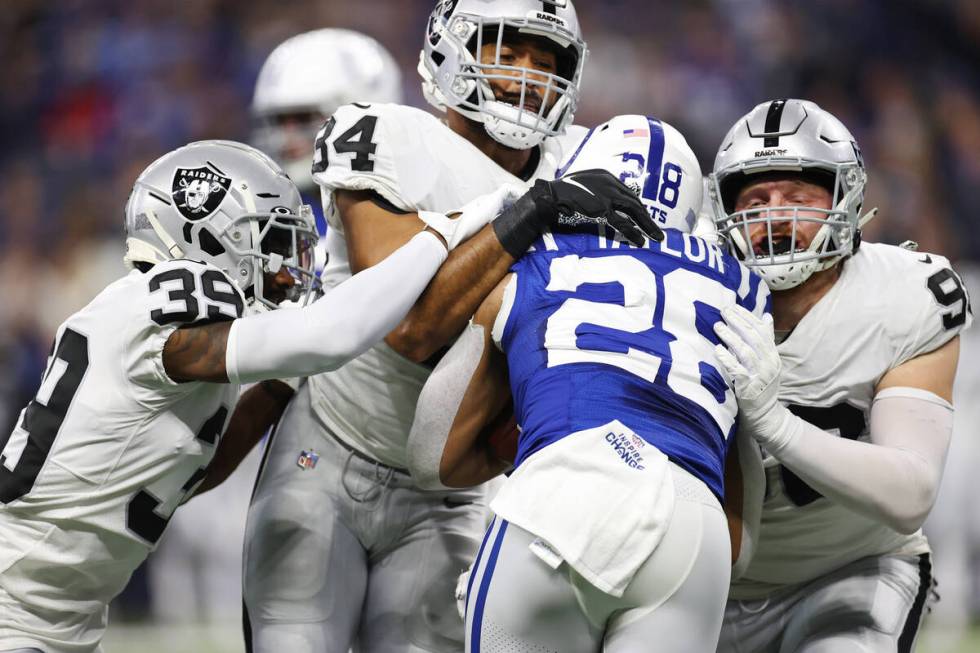 Raiders cornerback Nate Hobbs (39), outside linebacker K.J. Wright (34) and defensive end Maxx ...