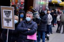 FILE - People wait in line at a COVID-19 testing site in New York's Times Square on Dec. 13, 20 ...