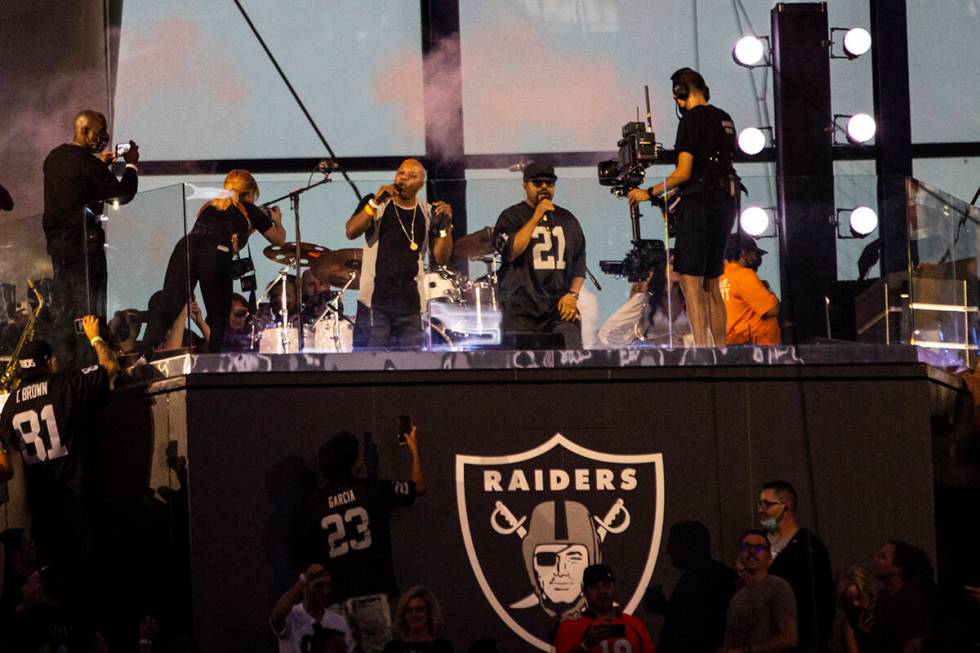 Too Short, center left, and Ice Cube perform during halftime at an NFL game between the Raiders ...