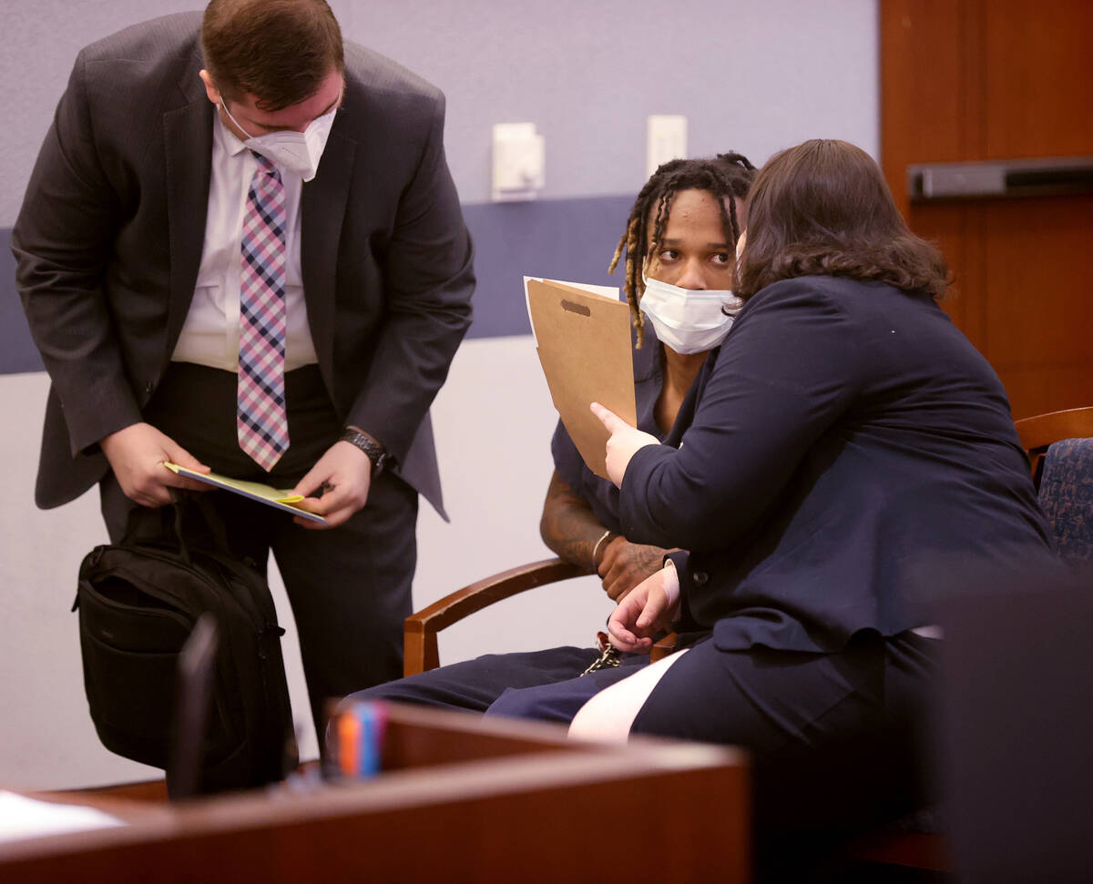 Jesani Carter, 20, talks to his attorneys in court at the Regional Justice Center in downtown L ...