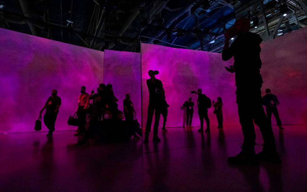 Attendees explore an immersive theater at the Panasonic booth during CES at the Las Vegas Conve ...