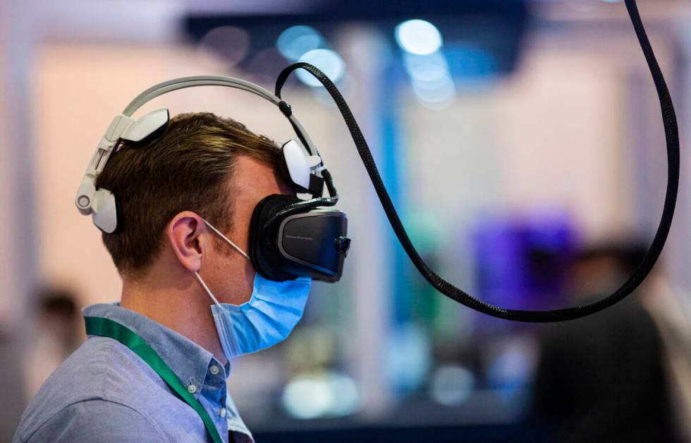 Thomas Ham, of London, plays a virtual reality game by VRLEO during CES at the Las Vegas Conven ...