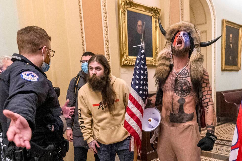 Jacob Chansley, right with fur hat, during the Capitol riot in Washington, Jan. 6, 2021. Chansl ...
