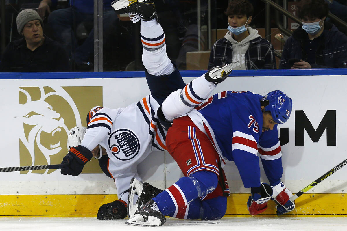 Edmonton Oilers' Colton Sceviour (70) falls over New York Rangers' Ryan Reaves (75) during the ...