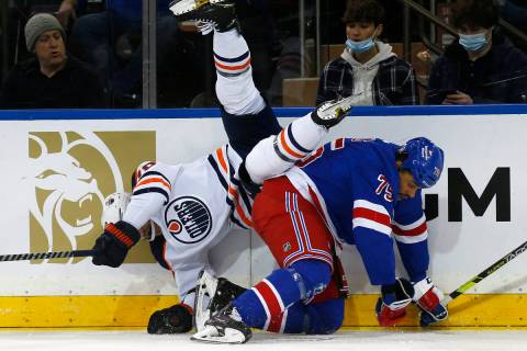 Edmonton Oilers' Colton Sceviour (70) falls over New York Rangers' Ryan Reaves (75) during the ...