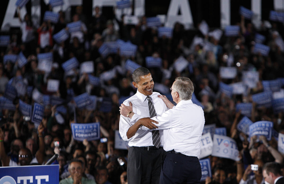 President Barack Obama embraces U.S. Senator Harry Reid, D-Nev., during a rally at Orr Middle S ...