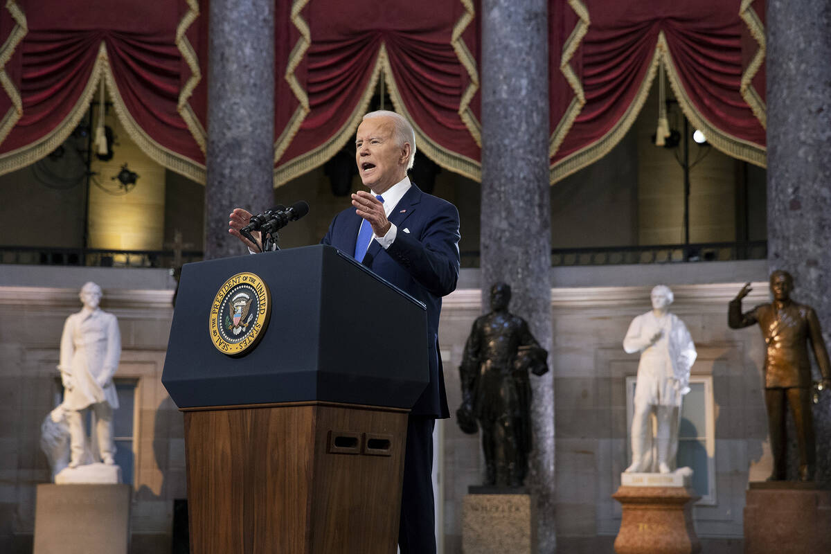 President Joe Biden speaks from Statuary Hall at the U.S. Capitol to mark the one year annivers ...