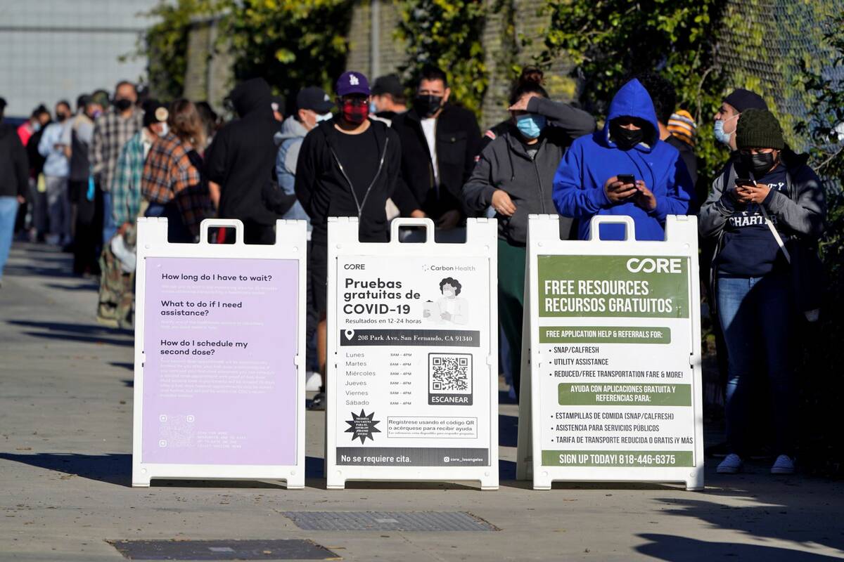 People line up at a COVID-19 testing center Wednesday, Jan. 5, 2022, in San Fernando, Calif. (A ...