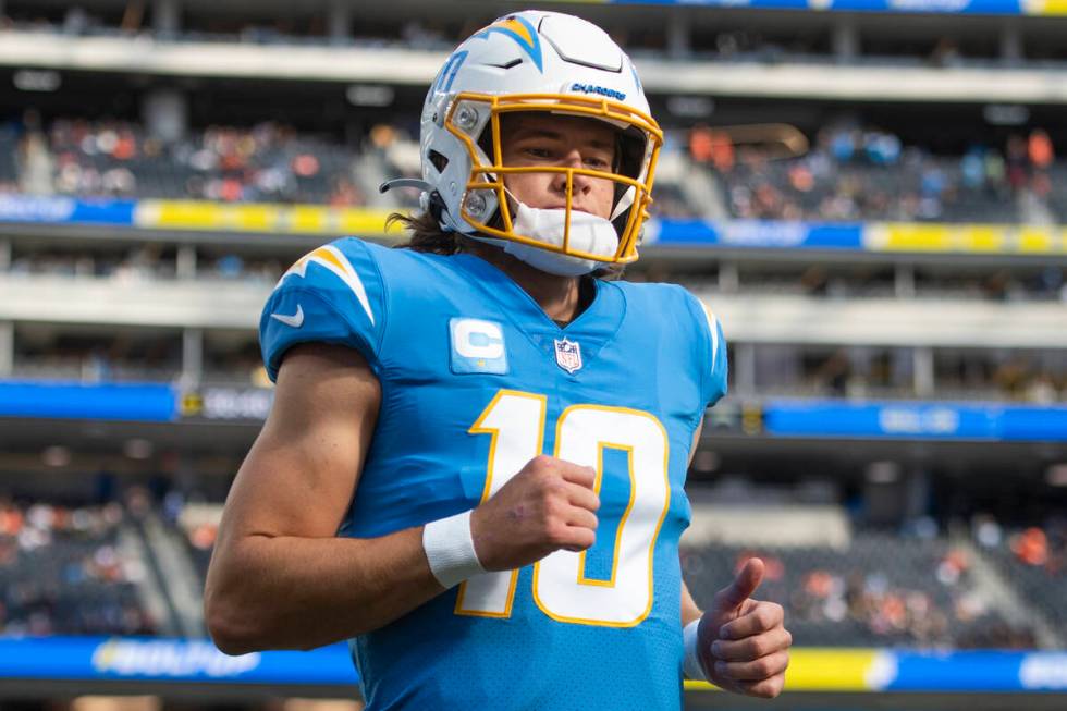 Los Angeles Chargers quarterback Justin Herbert (10) jogs back to the locker room before an NFL ...