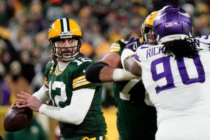 Green Bay Packers' Aaron Rodgers thorws during the first half of an NFL football game against t ...