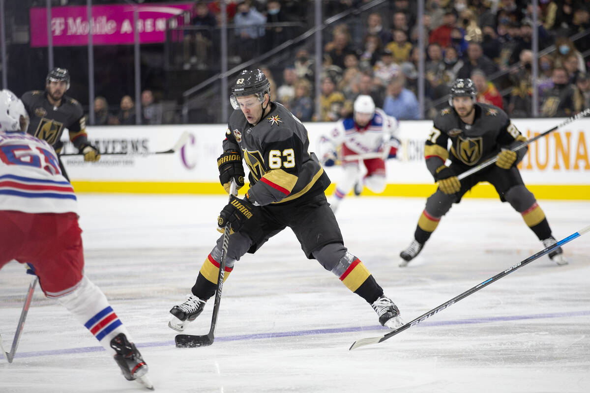 Golden Knights right wing Evgenii Dadonov (63) gains control of the puck while Rangers defensem ...