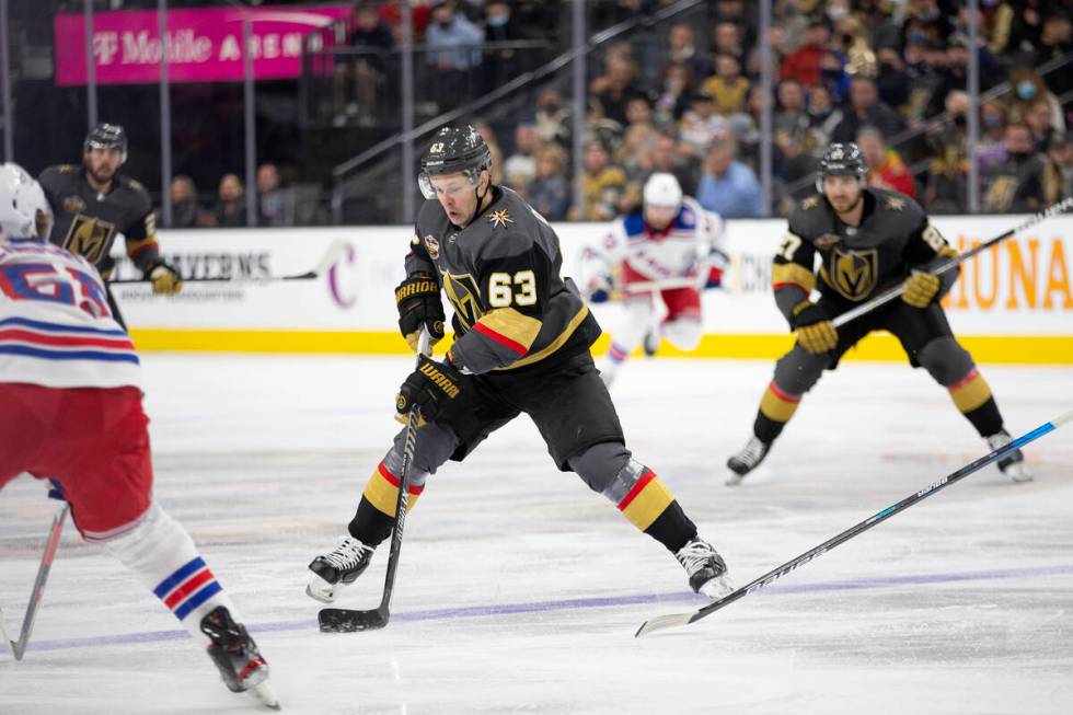 Golden Knights right wing Evgenii Dadonov (63) gains control of the puck while Rangers defensem ...