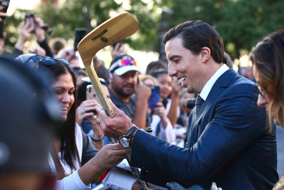 Golden Knights' Marc-Andre Fleury (29) signs autographs on the gold carpet after arriving for t ...