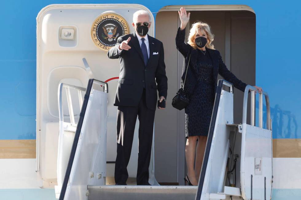 President Joe Biden and first lady Jill Biden wave as they board Air Force One upon departure a ...