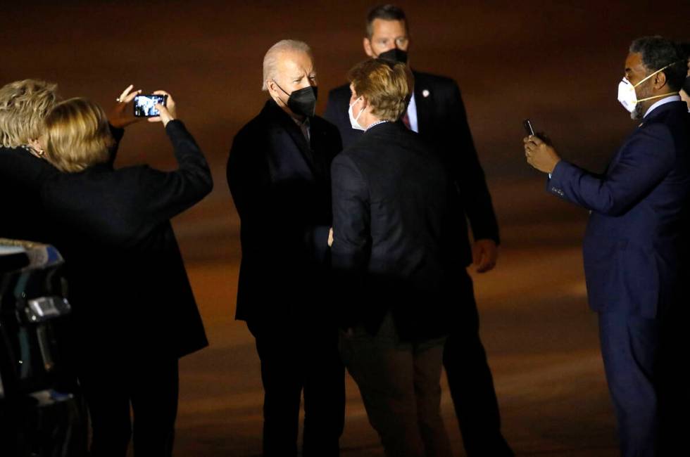 President Joe Biden, center, greets people after he arrived on Air Force One at Harry Reid Inte ...