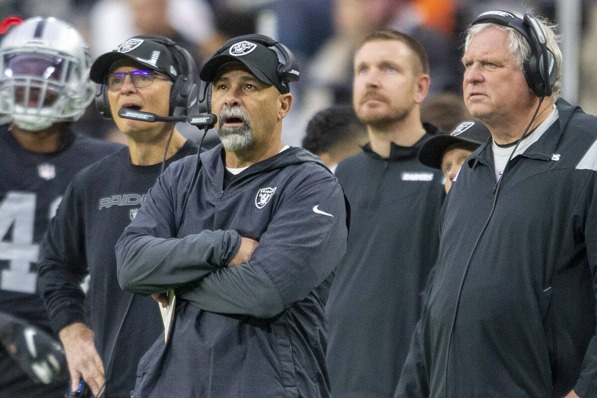 Raiders interim head coach Rich Bisaccia, center, reacts to a penalty agains the team with Raid ...