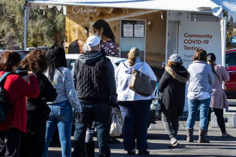 People line up to get tested for COVID-19 outside of the West Flamingo Senior Center on Tuesday ...