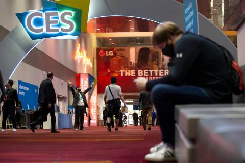 In Uk Jung, of South Korea, third from left, poses for a photo during the third day of the CES ...
