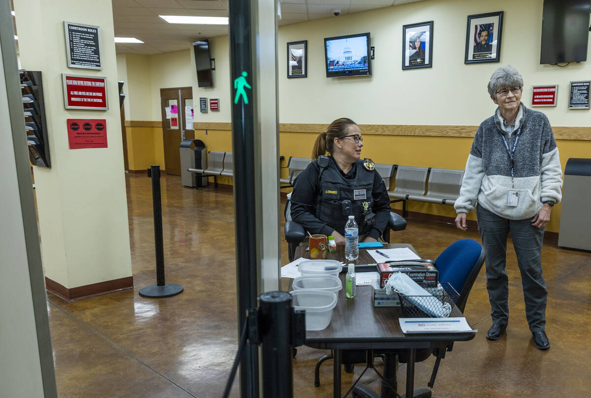 Nye County District Judge Kim Wanker, right, joins bailiff A. Fernandes on Jan. 6, 2022, near t ...