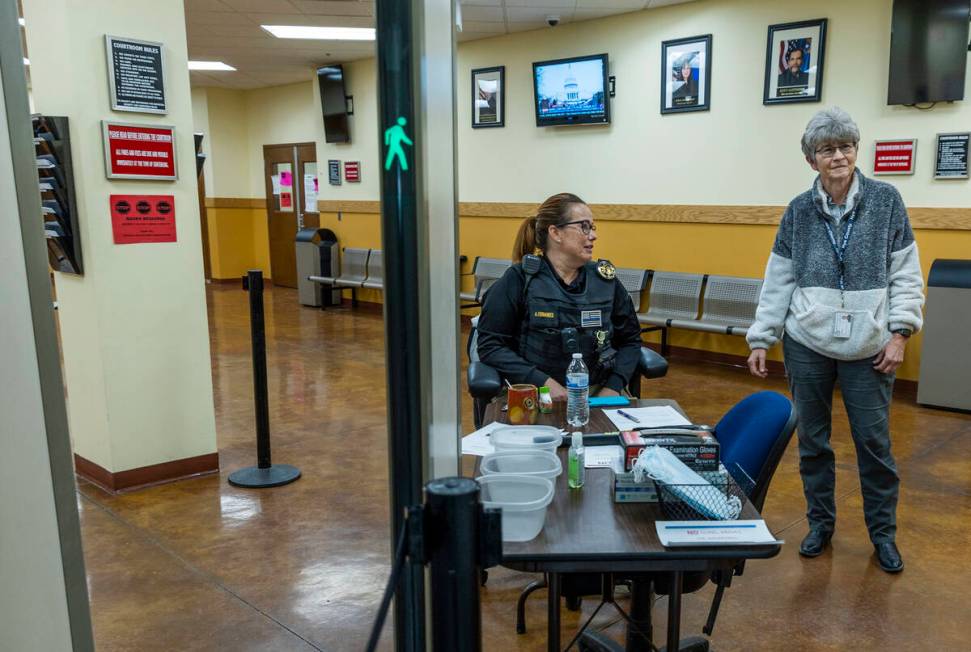 Nye County District Judge Kim Wanker, right, joins bailiff A. Fernandes on Jan. 6, 2022, near t ...