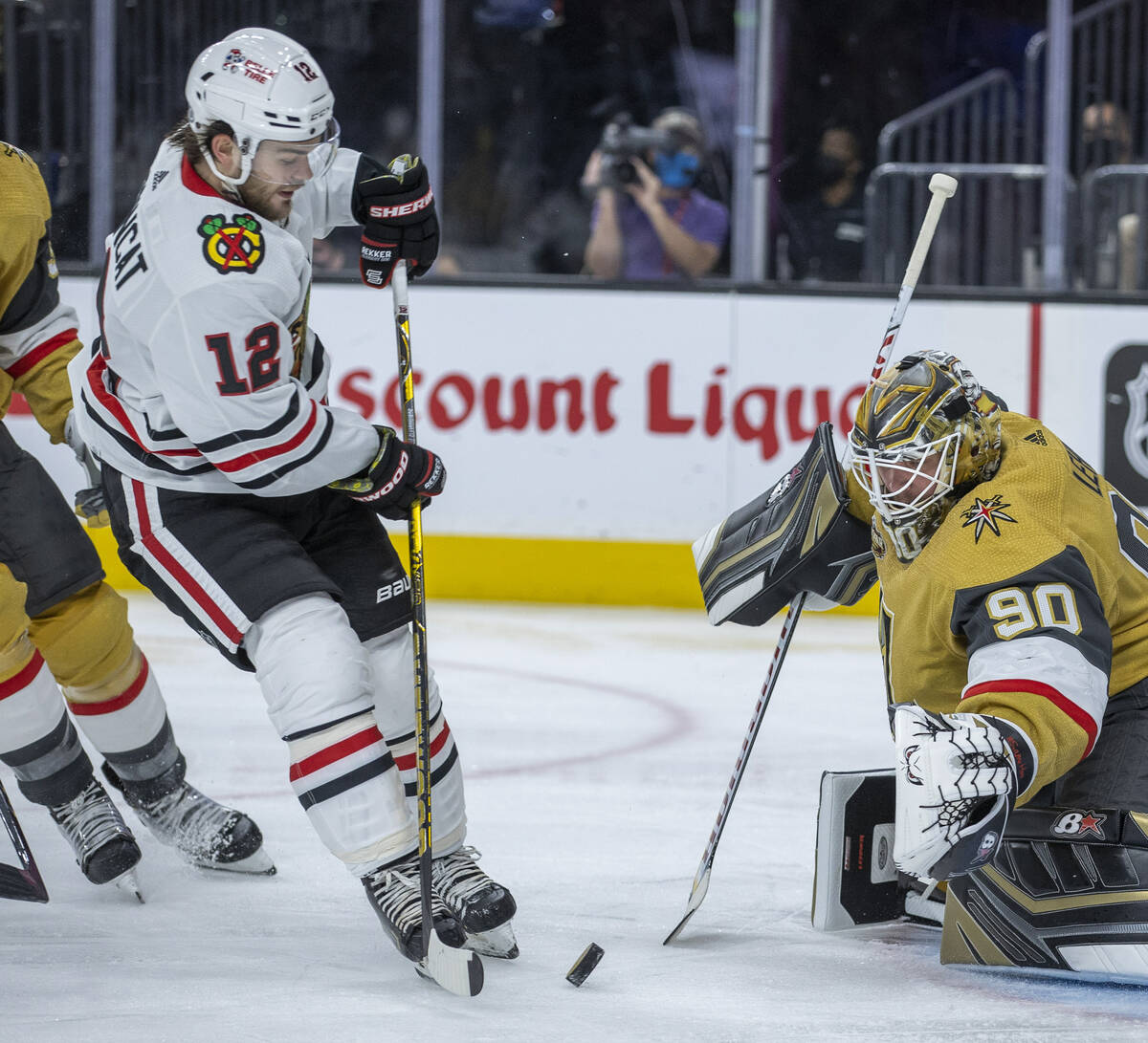 Golden Knights goaltender Robin Lehner (90) defends a shot by Chicago Blackhawks left wing Alex ...