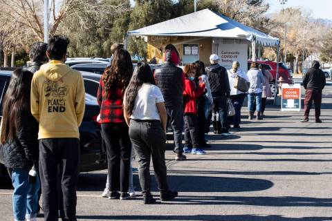 People line up to get tested for COVID-19 outside of the West Flamingo Senior Center on Tuesday ...