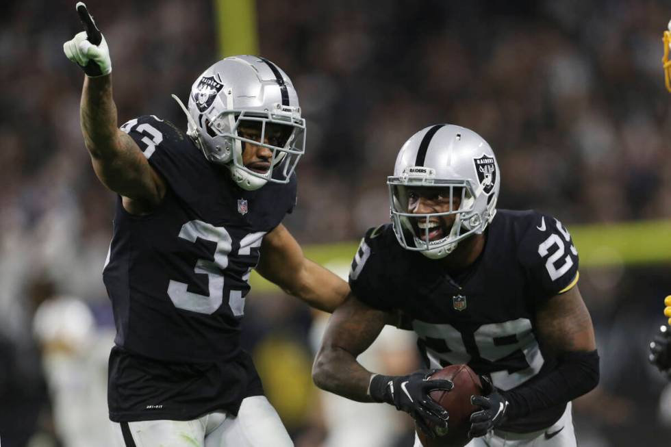 Las Vegas Raiders safety Roderic Teamer (33) celebrates after cornerback Casey Hayward, right, ...