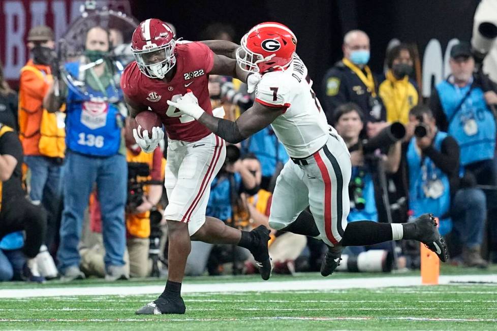 Alabama's Brian Robinson Jr. runs for a first down past Georgia's Quay Walker during the second ...