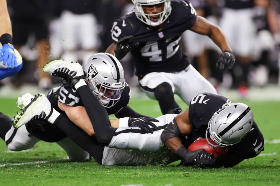 Raiders linebacker Divine Deablo (5) recovers a fumble as Raiders inside linebacker Will Compto ...