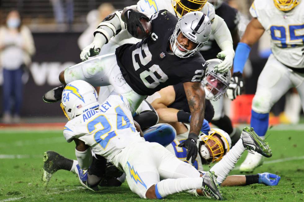 Raiders running back Josh Jacobs (28) runs the ball against the Los Angeles Chargers in the sec ...