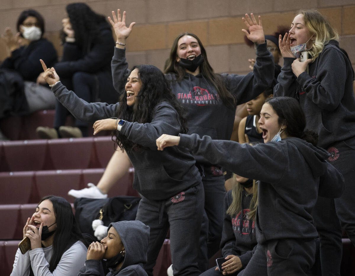 Fans cheer for Desert Oasis in the third quarter during a girls high school basketball game aga ...