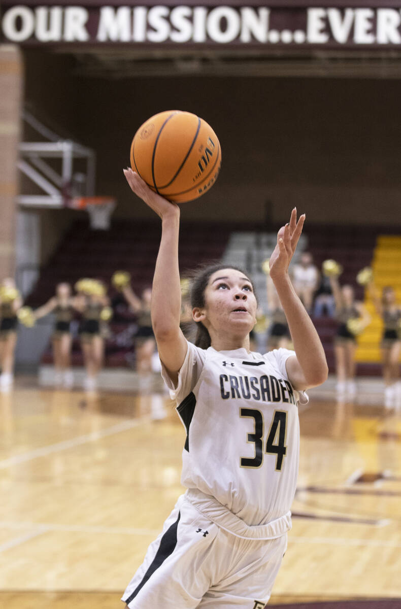 Faith Lutheran’s Leah Mitchell (34) drives to the rim in the first quarter during a girl ...
