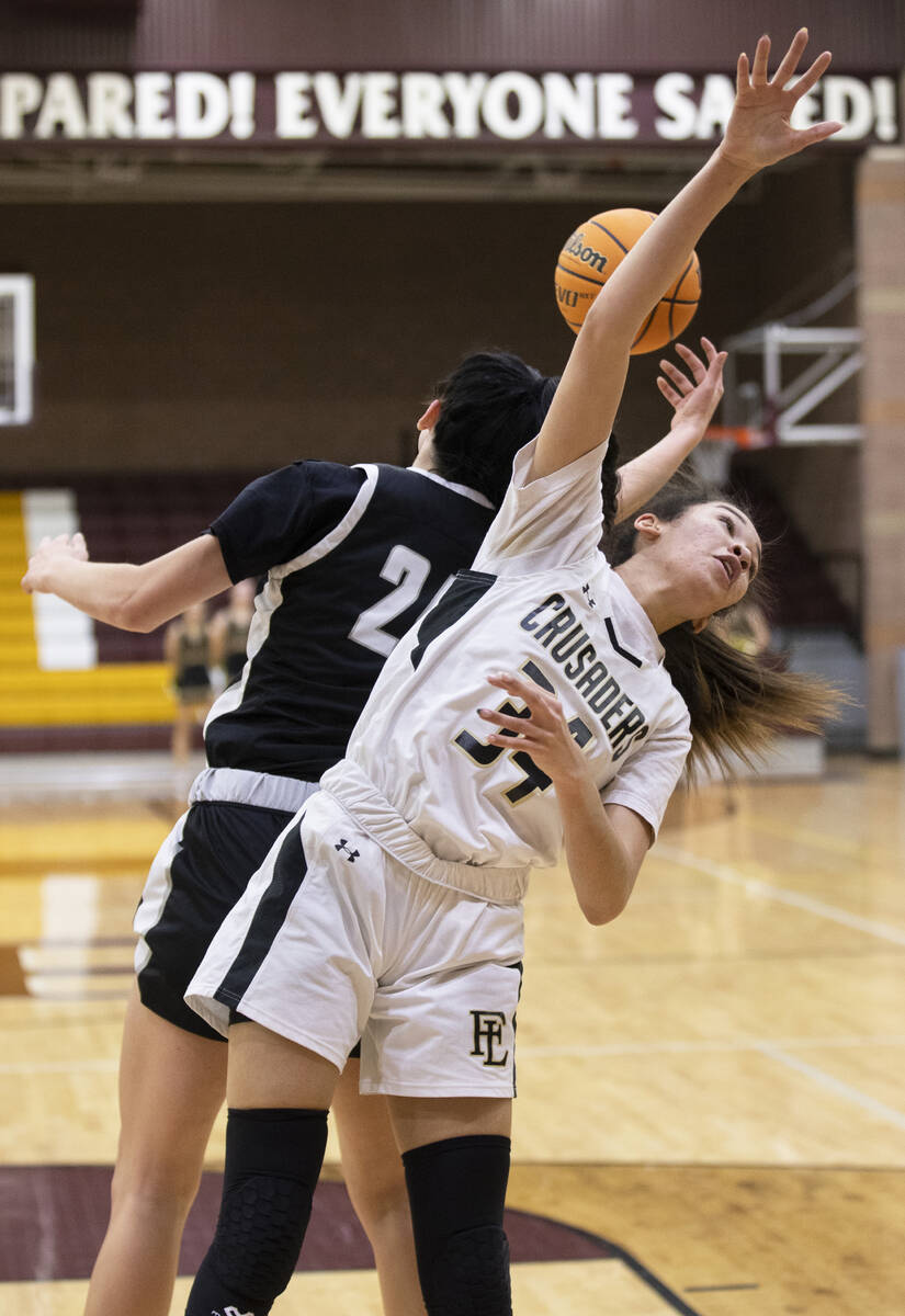 Faith Lutheran’s Leah Mitchell (34) fights for a loose ball with Desert Oasis’ Pa ...