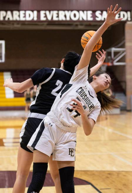 Faith Lutheran’s Leah Mitchell (34) fights for a loose ball with Desert Oasis’ Pa ...