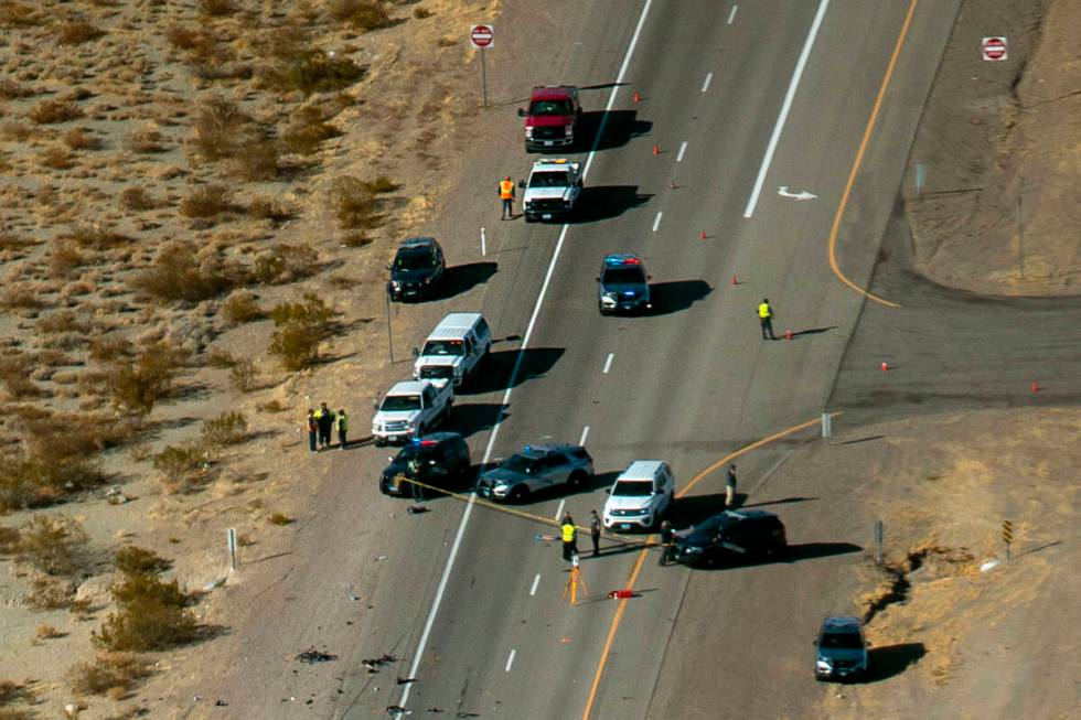 The Nevada Highway Patrol works the scene of a fatal crash involving multiple bicyclists and a ...